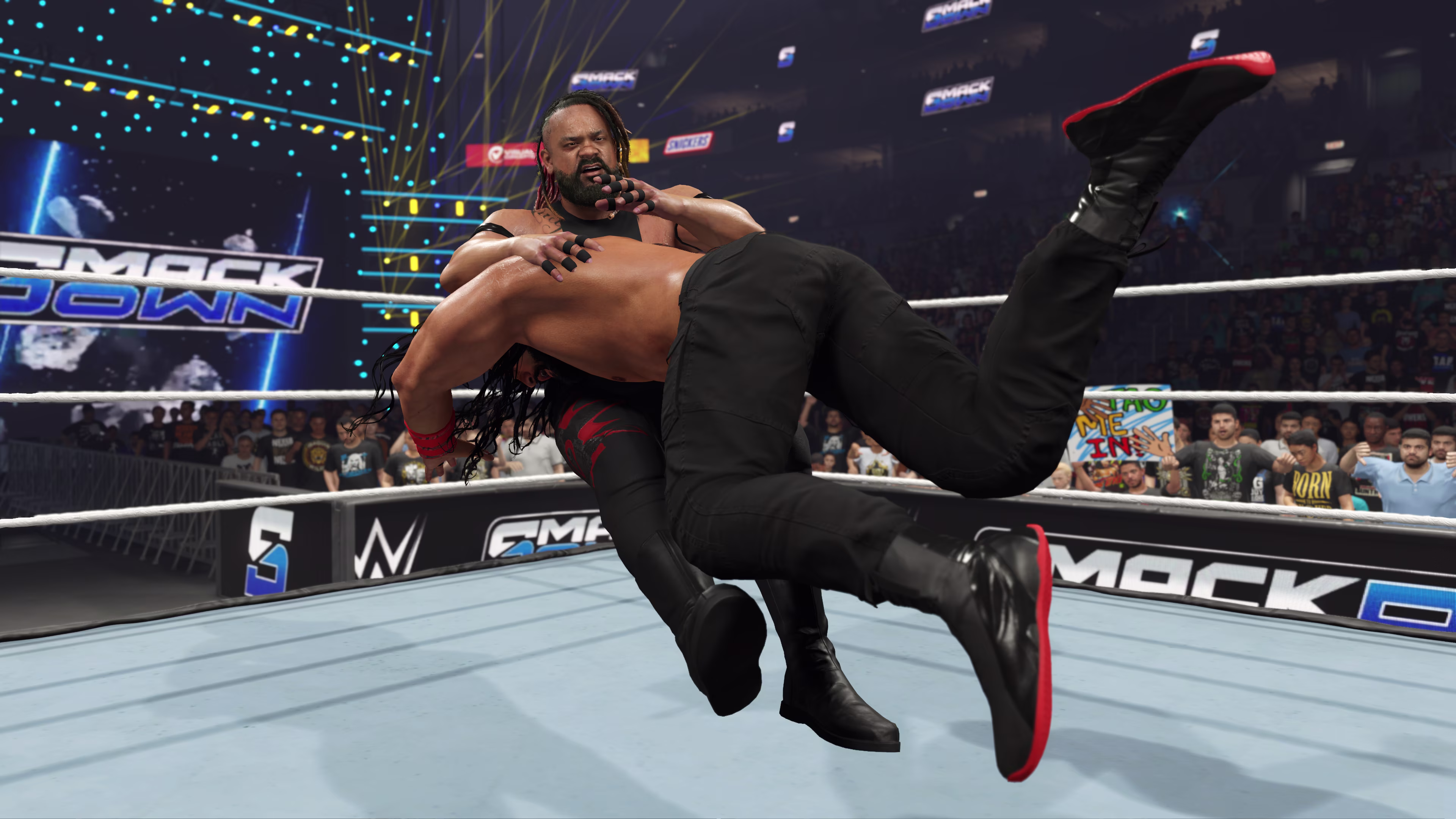 Roman Reigns spears Jacob Fatu on Friday Night Smack Down in *WWE 2K25*
